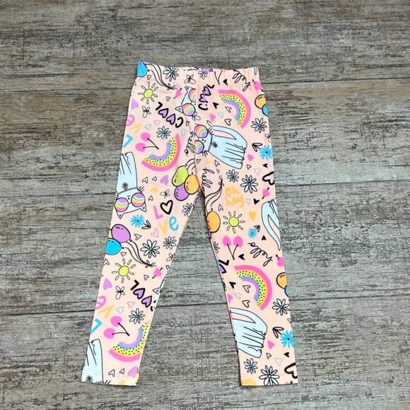 Flat lay of Rainbow Kitty leggings with colourful rainbow and cat prints