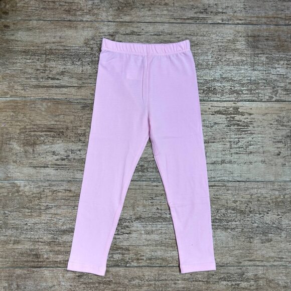 Flat lay of Sweet Blossom cotton leggings on wooden floor