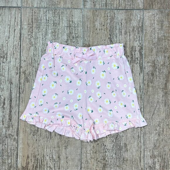 Flat lay of pink daisy cotton shorts for girls