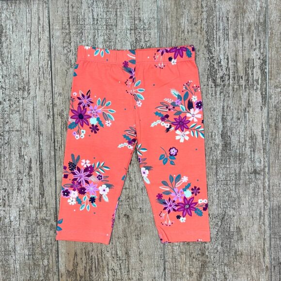 Coral floral baby leggings flat lay